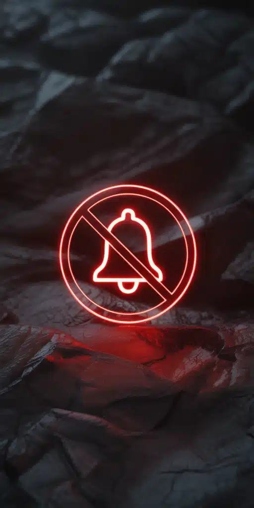 This powerful wallpaper features a glowing red neon “Do Not Disturb” bell icon crossed out, placed against a textured black rock background. With intense shadows and vibrant lighting, it’s a dramatic design ideal for Do Not Disturb Wallpaper Black and Phone On Dnd users. The bold contrast and high-impact design make it perfect for iPhones set to silent mode with style.
