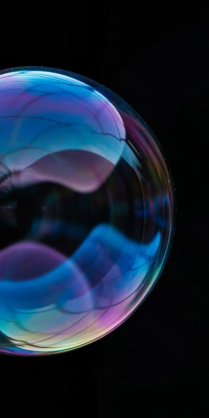 This dreamy wallpaper displays a close-up of an iridescent orb that resembles a planet, showcasing fluid bands of magenta, teal, and violet swirling on a reflective surface. The deep black background adds contrast, making the colors pop in vivid detail. Ideal for lovers of planet wallpaper iphone and cool themes for phone, it adds a whimsical, celestial feel to your screen. A perfect match for anyone seeking an artistic, abstract space aesthetic.